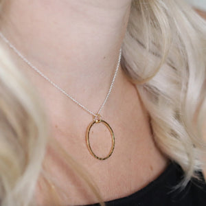 Gold hammered circle pendant on silver chain